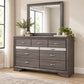 Seville Weathered Grey dresser and mirror in a bedroom lifestyle setting