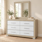 Emma Natural & White dresser and mirror in a bedroom lifestyle setting